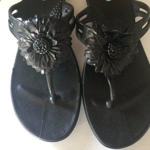 Black floral thong style slip on sandals say size M/L